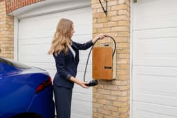 A wall-mounted Level 2 EV charger in a home garage